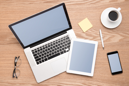 Responsive mock-up of laptop, digital tablet and smartphone, top view on a desktopの写真素材