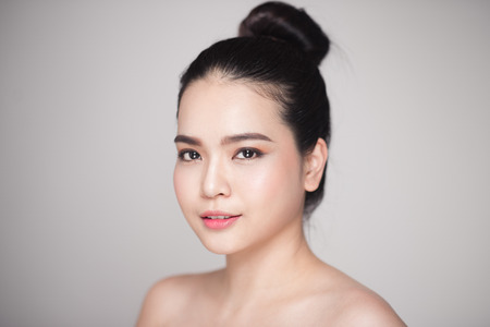 Beauty concept. Asian pretty woman with perfect skin looking at cameraの写真素材