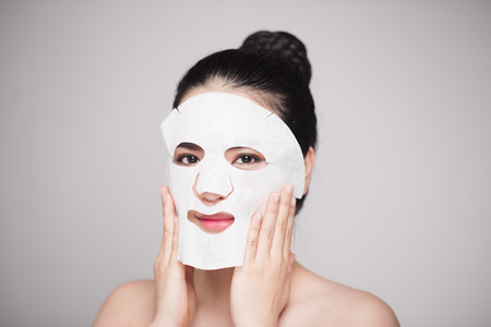 Spa, healthcare. Woman with purifying mask on her face isolated on white backgroundの写真素材