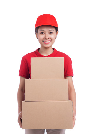 Portrait of delivery woman service happily delivering package to costumerの写真素材