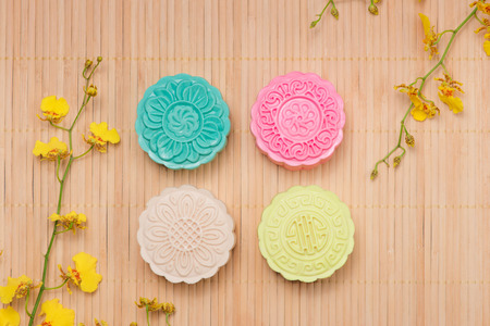 Sweet color of snow skin mooncake. Traditional mid autumn festival foods with tea on table setting.の写真素材