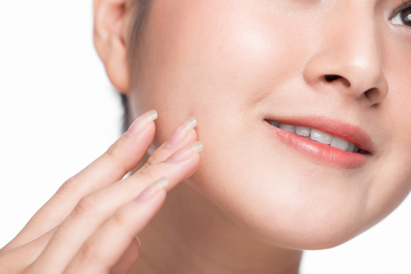Skin care. Beautiful Young Asian Woman with Clean Fresh Skin touch her faceの写真素材