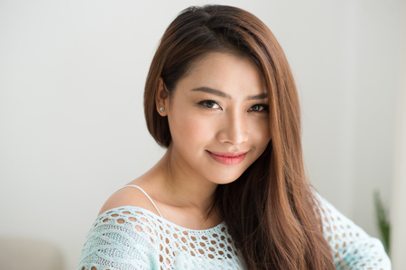 Young asian woman relaxing at her home.の写真素材