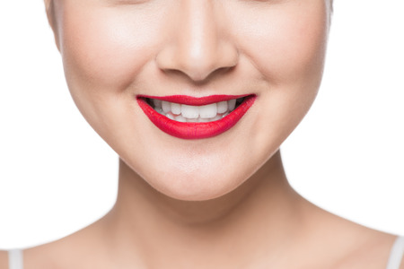Beautiful asian face with red lips over white.の写真素材