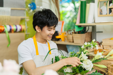Portrait of smiling flower shop owner working. Small business.の写真素材