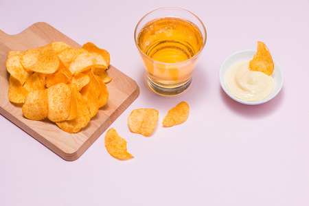 Cheese and onion potato chips with soft drink on pink background.の写真素材