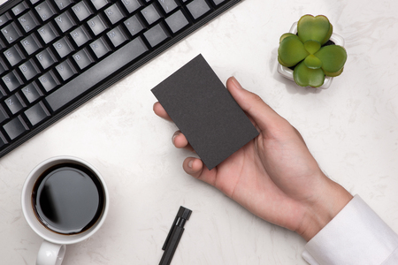 Mockup of black business cards in man's handの写真素材