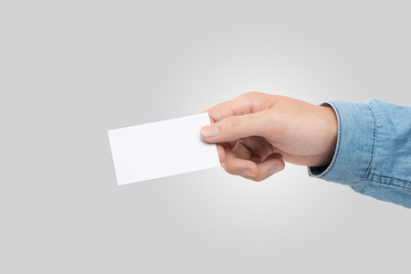 Male hand holding blank business card isolatedの写真素材