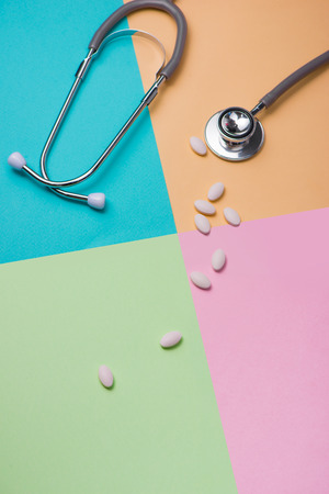 Medical concept. The stethoscope and pills on colorful background.の写真素材