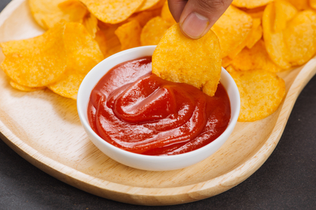 Potato chips and ketchup. Beer snack, unhealthy eatingの写真素材
