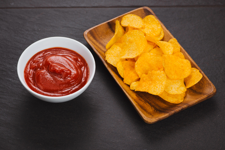 Potato chips and ketchup. Beer snack, unhealthy eatingの写真素材