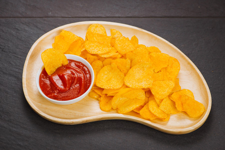 Potato chips and ketchup. Beer snack, unhealthy eatingの写真素材