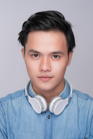 Smart casual asian man with headphone in studio backgroundの写真素材