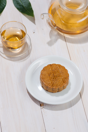 Retro vintage style Chinese mid autumn festival foods. Traditional mooncakes on table settingの写真素材