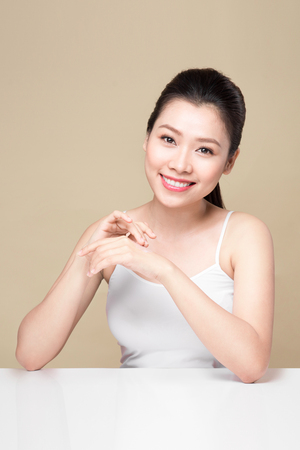 Clean fresh skincare concept. Young asian woman touching enjoying hand skin.の写真素材