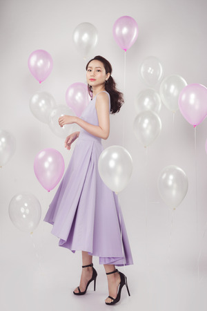 Asian pretty fashionable woman with pastel balloonsの写真素材