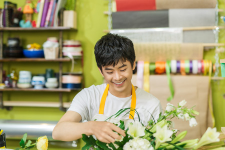 Portrait of smiling flower shop owner working. Small business.の写真素材
