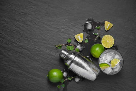 Mojito cocktail with lime and mint on dark stone tableの写真素材