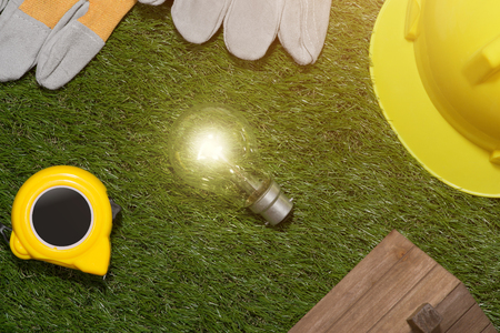 Green building and energy saving concept: house projecj and work tools on the grassの写真素材