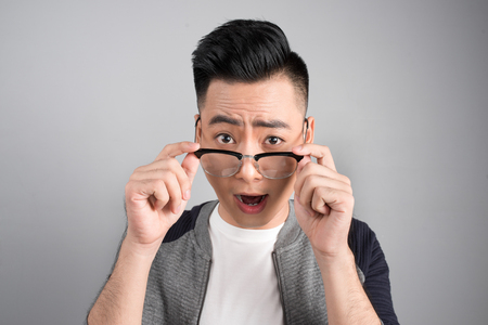 A portrait of asian man with surprised emotion faceの写真素材