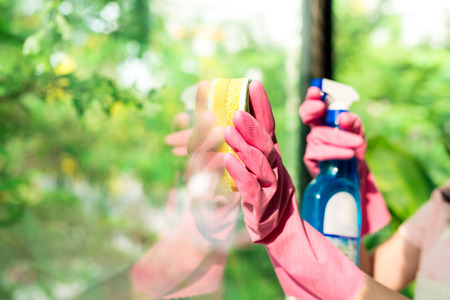 Close up of woman's hand with special rag cleaning windowの写真素材