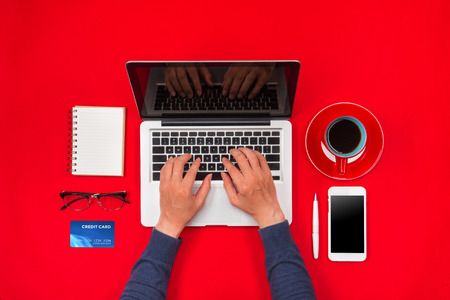 Male hands making a payment using a credit card, online shopping conceptの写真素材