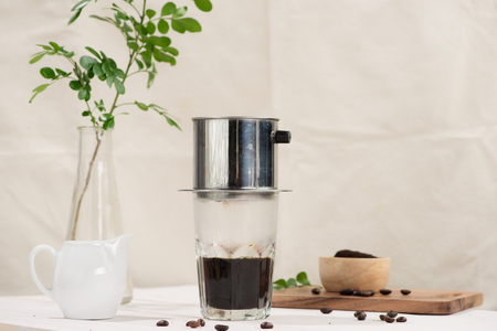 Coffee dripping in vietnamese style on wooden tableの写真素材