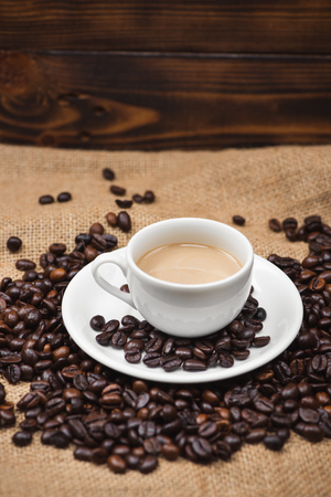 Coffee cup and beans on a rustic backgroundの写真素材