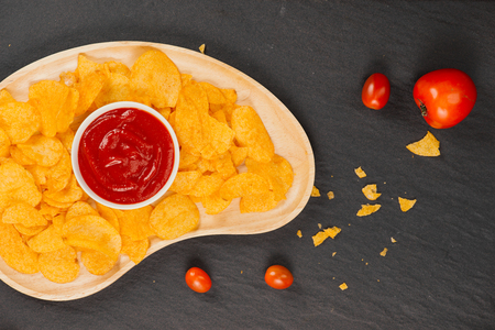 Potato chips and ketchup. Beer snack, unhealthy eatingの写真素材