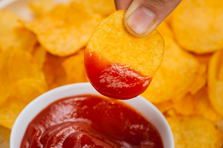 Potato chips and ketchup. Beer snack, unhealthy eatingの写真素材
