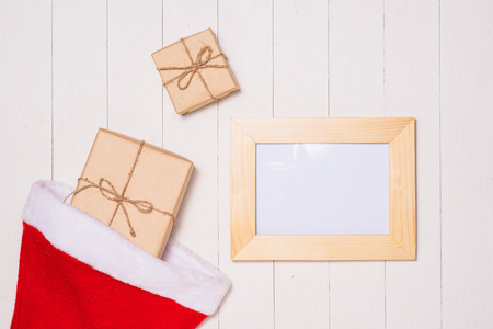 Christmas presents in decorative boxes on white wooden table backgroundの写真素材