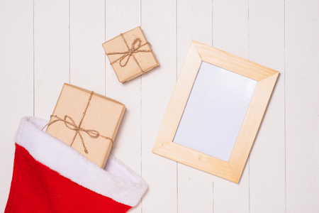 Christmas presents in decorative boxes on white wooden table backgroundの写真素材