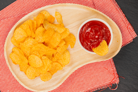 Potato chips and ketchup. Beer snack, unhealthy eatingの写真素材