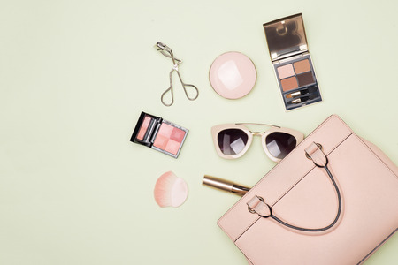 Makeup products with cosmetic bag on color backgroundの写真素材