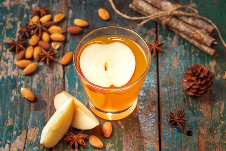 Hot drink of apple tea with cinnamon stick. Hot drink with apples for autumn or winter.の写真素材