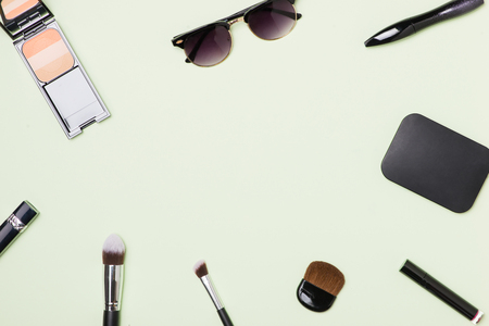A collection of make up and cosmetic beauty green backgroundの写真素材