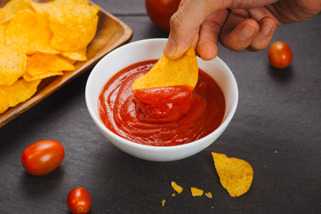 Potato chips and ketchup. Beer snack, unhealthy eatingの写真素材