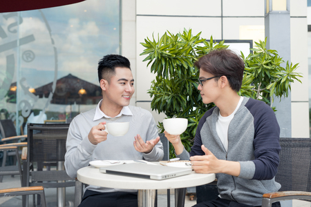 Business partners working in team, discussing issuesand sharing new ideasの写真素材