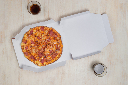 Pizza in a cardboard box. Space for text. View from above. Pizza delivery. Pizza menu.の写真素材