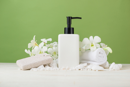 SPA Decoration. Spa composition with cosmetic bottle over green.の写真素材