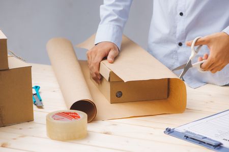 Delivery man packing up on work place in post officeの写真素材