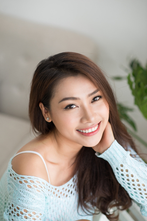 Young asian woman relaxing at her home.の写真素材