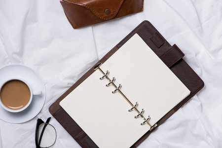 Morning Coffee and Diary with wooden pencil on cloth top view, woman creative business conceptの写真素材