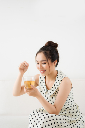 Young attractive asian woman drinking hot teaの写真素材