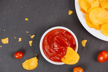 Potato chips and ketchup. Beer snack, unhealthy eatingの写真素材