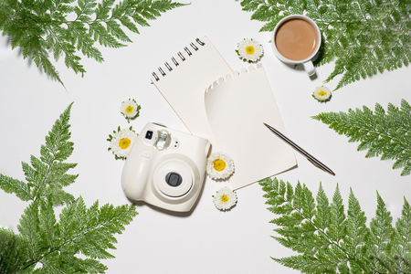 Creative flat lay morning coffee and flowers with notebookの写真素材