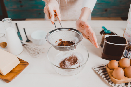 House wife wearing apron making. Steps of making cooking chocolate cake.の写真素材