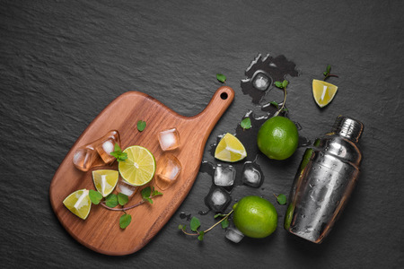 Mojito cocktail with lime and mint in glass on a grey stone backgroundの写真素材