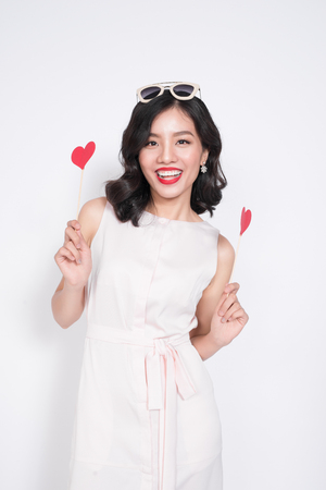Fashionable woman in nice dresses holding red heart shape.の写真素材