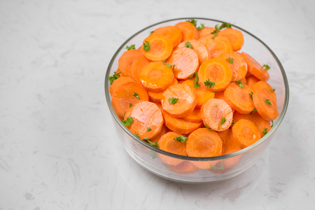 Chopped carrot slices. Fresh raw peeled carrot slice in bowl.の写真素材